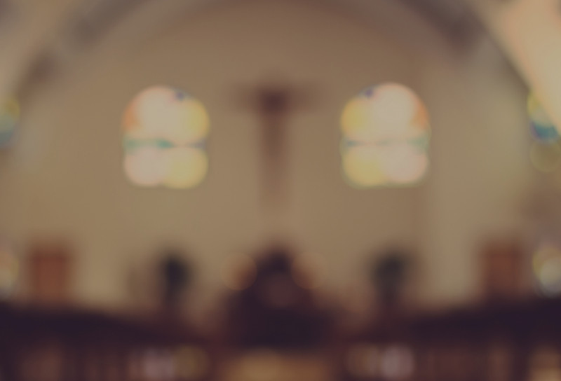A blurred image of a church interior evoking a sense of sanctuary
